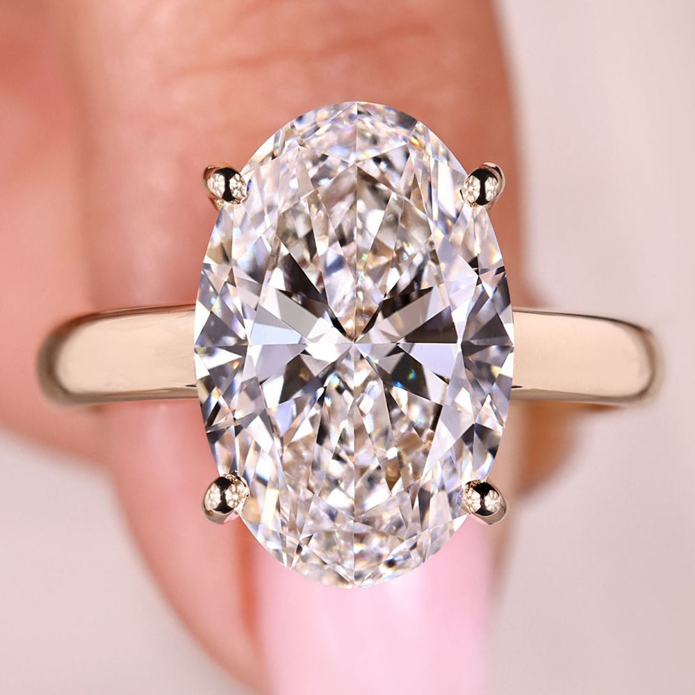 Lab grown oval cut hidden halo diamond ring.
