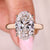 Lab grown oval cut hidden halo diamond ring.
