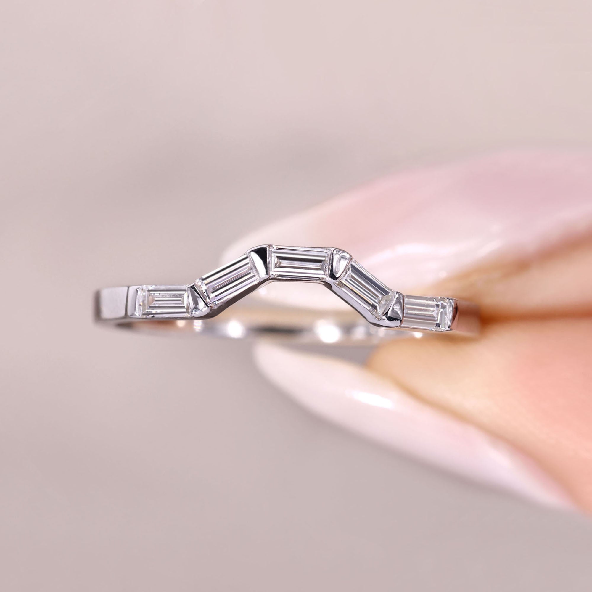 Elegant baguette diamond band in bar setting.
