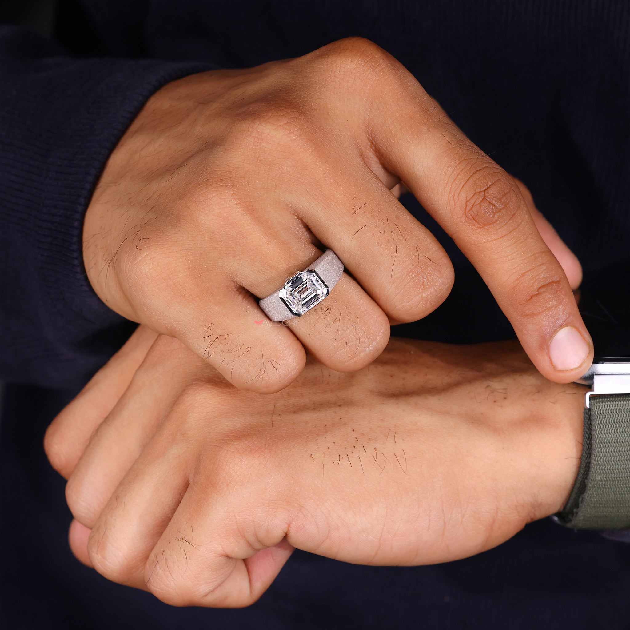 Emerald and baguette diamond ring blends classic design with modern elegance.
