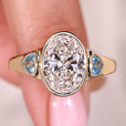 Bezel set oval diamond ring in yellow gold setting.