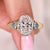 Bezel set oval diamond ring in yellow gold setting.