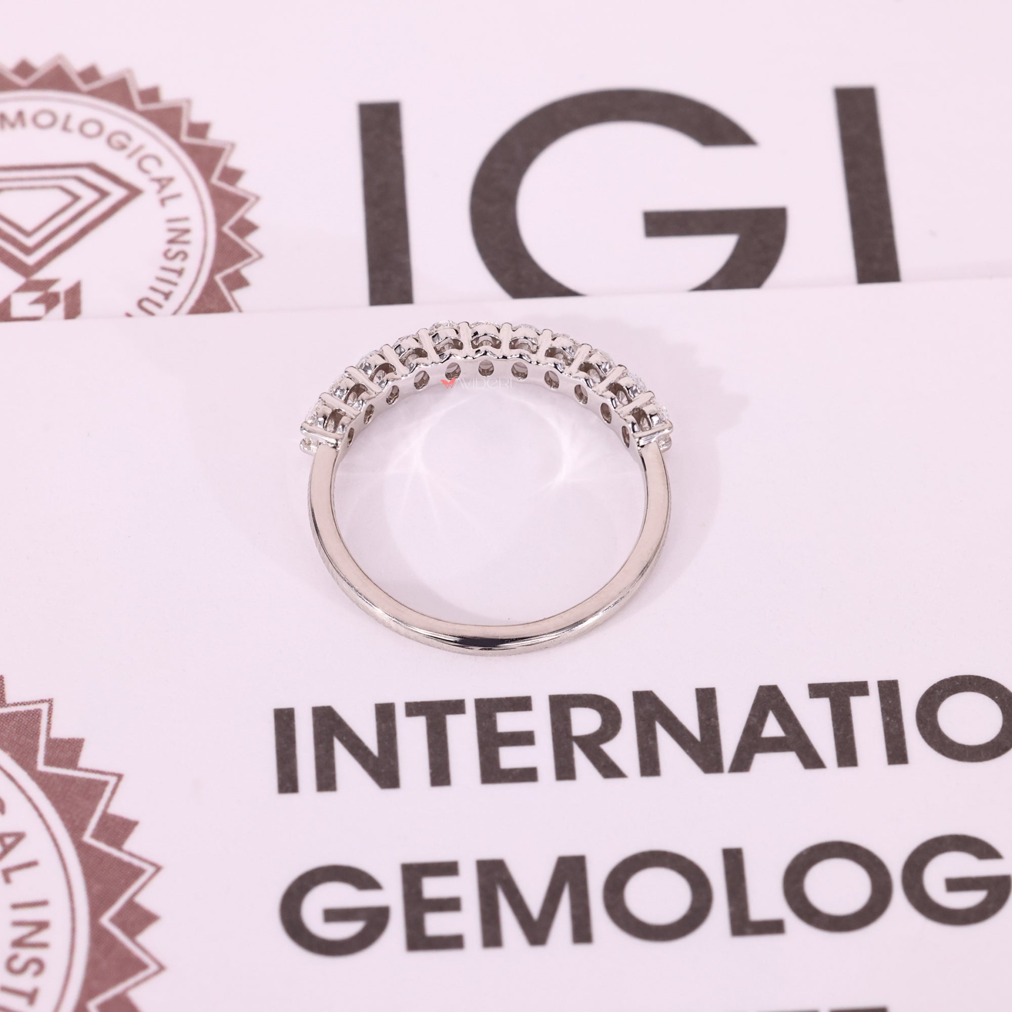 White gold band with oval cut diamond accents.