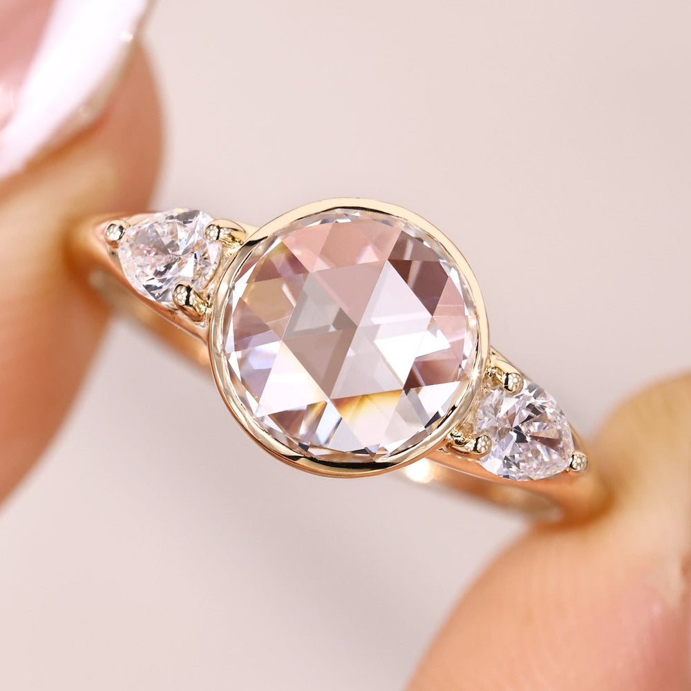 Bezel setting engagement ring with three stone bezel ring.
