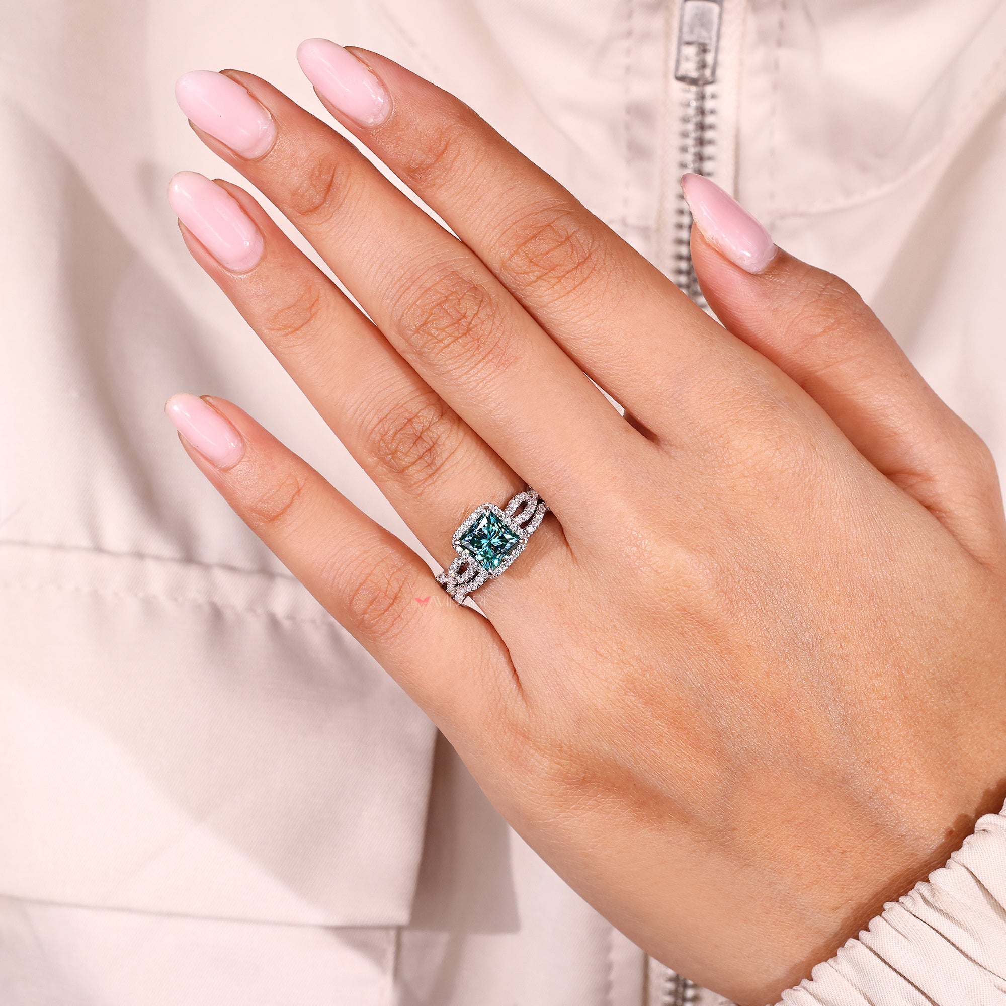 White gold halo set ring with brilliant stones surrounding the center.
