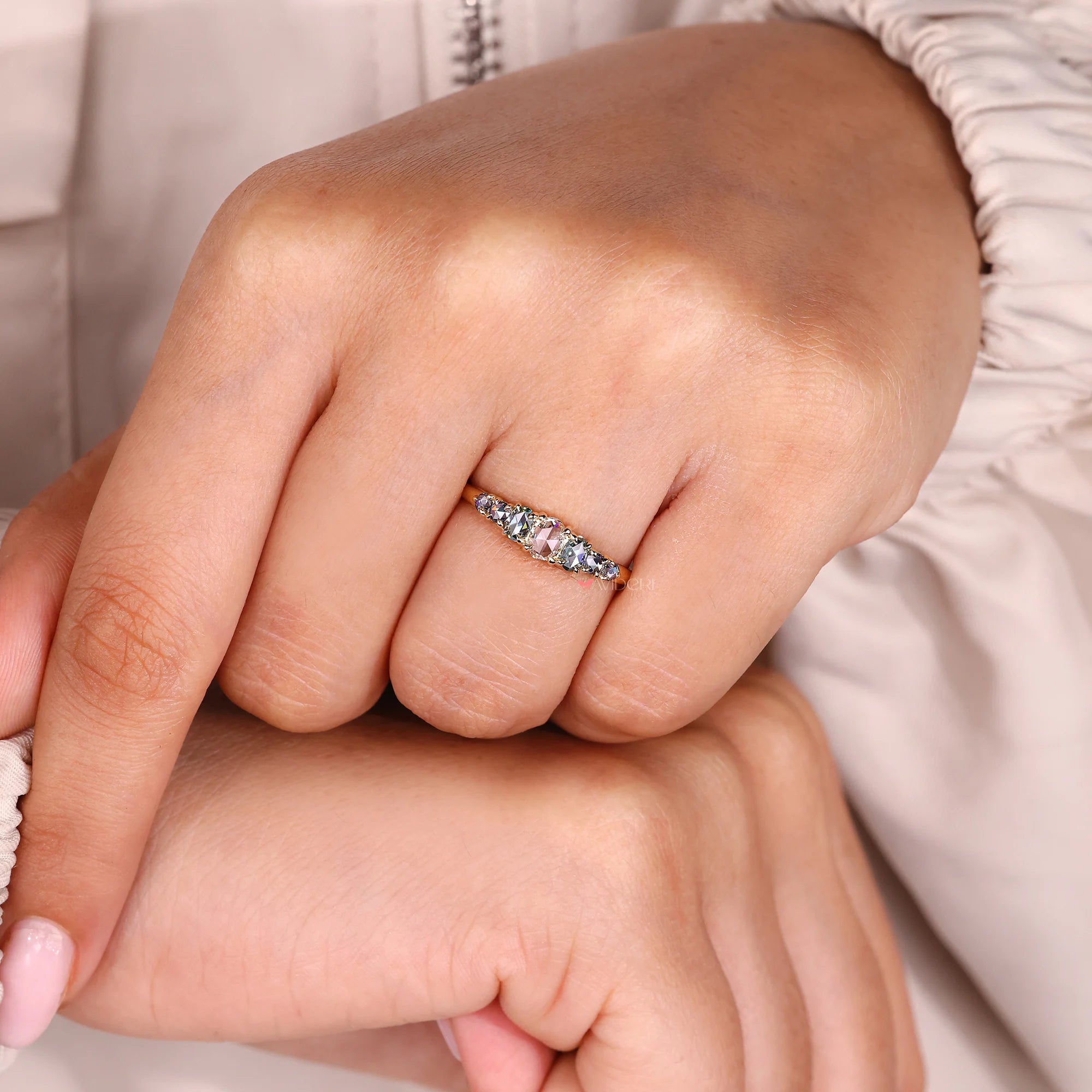 4 claw prong setting on a half eternity band.