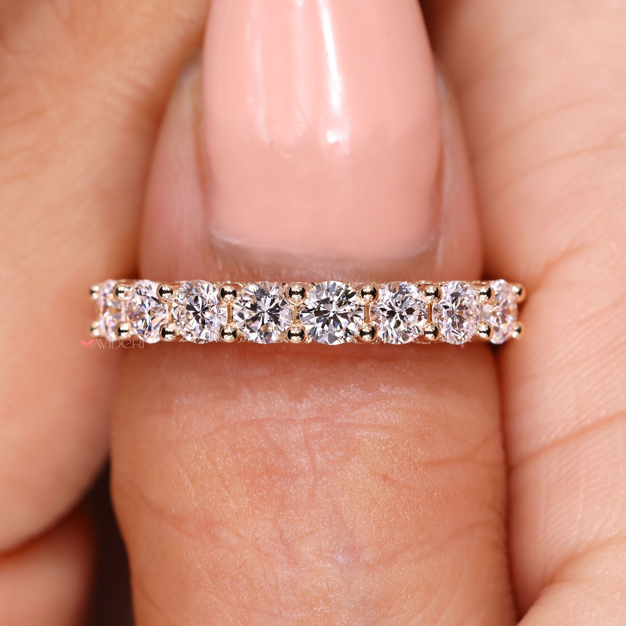 Shared prong diamond wedding band in yellow gold.