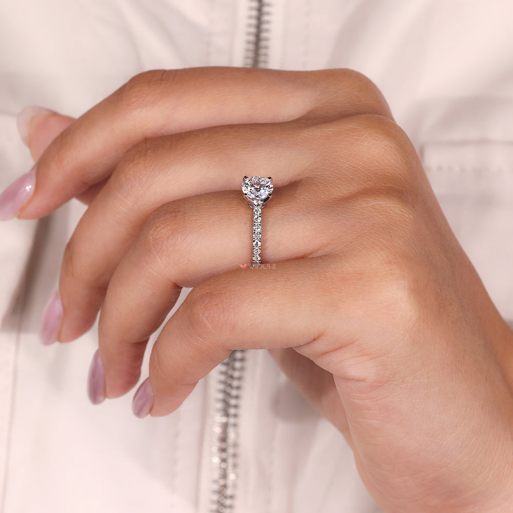 Custom engagement ring with a round diamond, made to fit her style.
