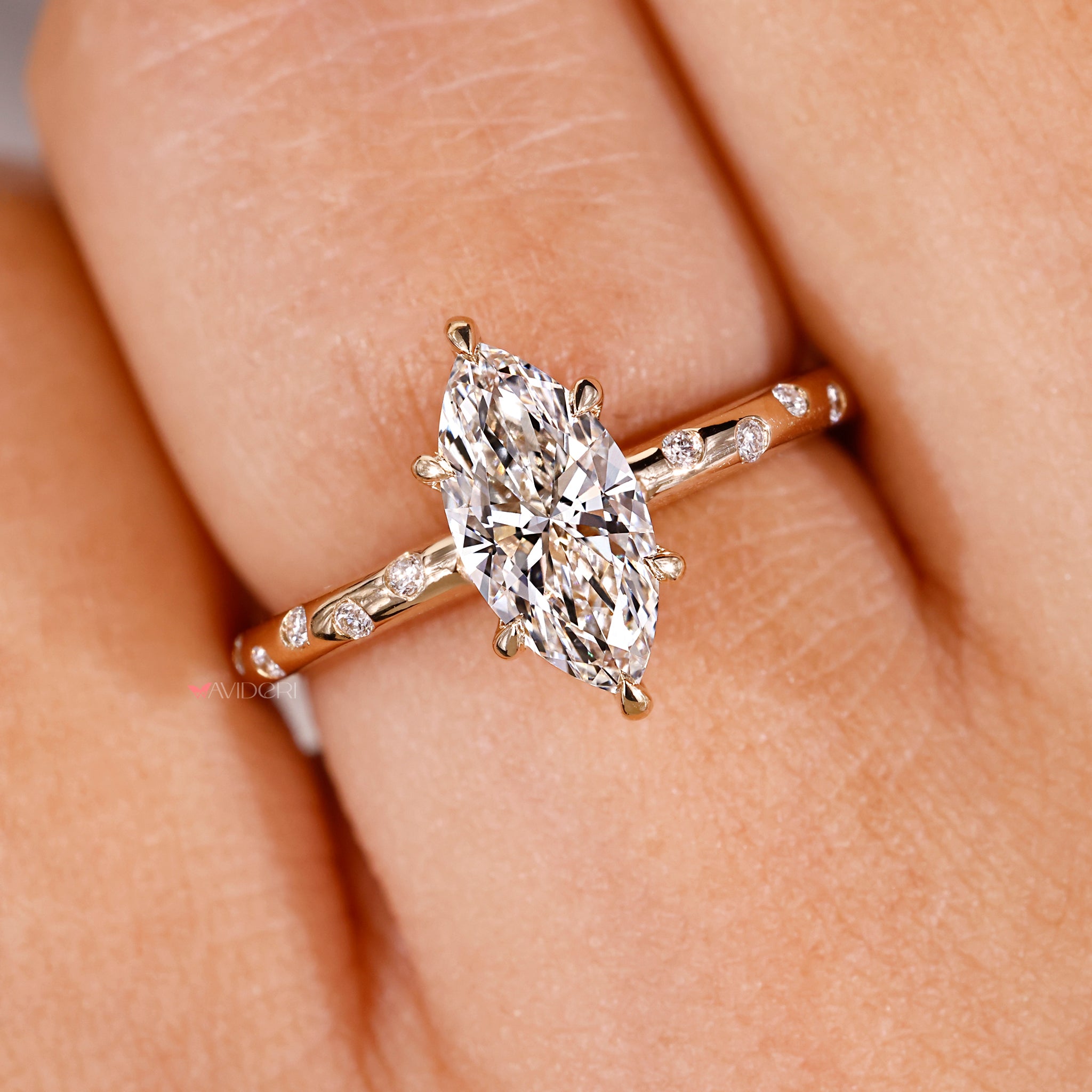 6-claw prong setting ring with round diamonds and marquise accents in yellow gold.