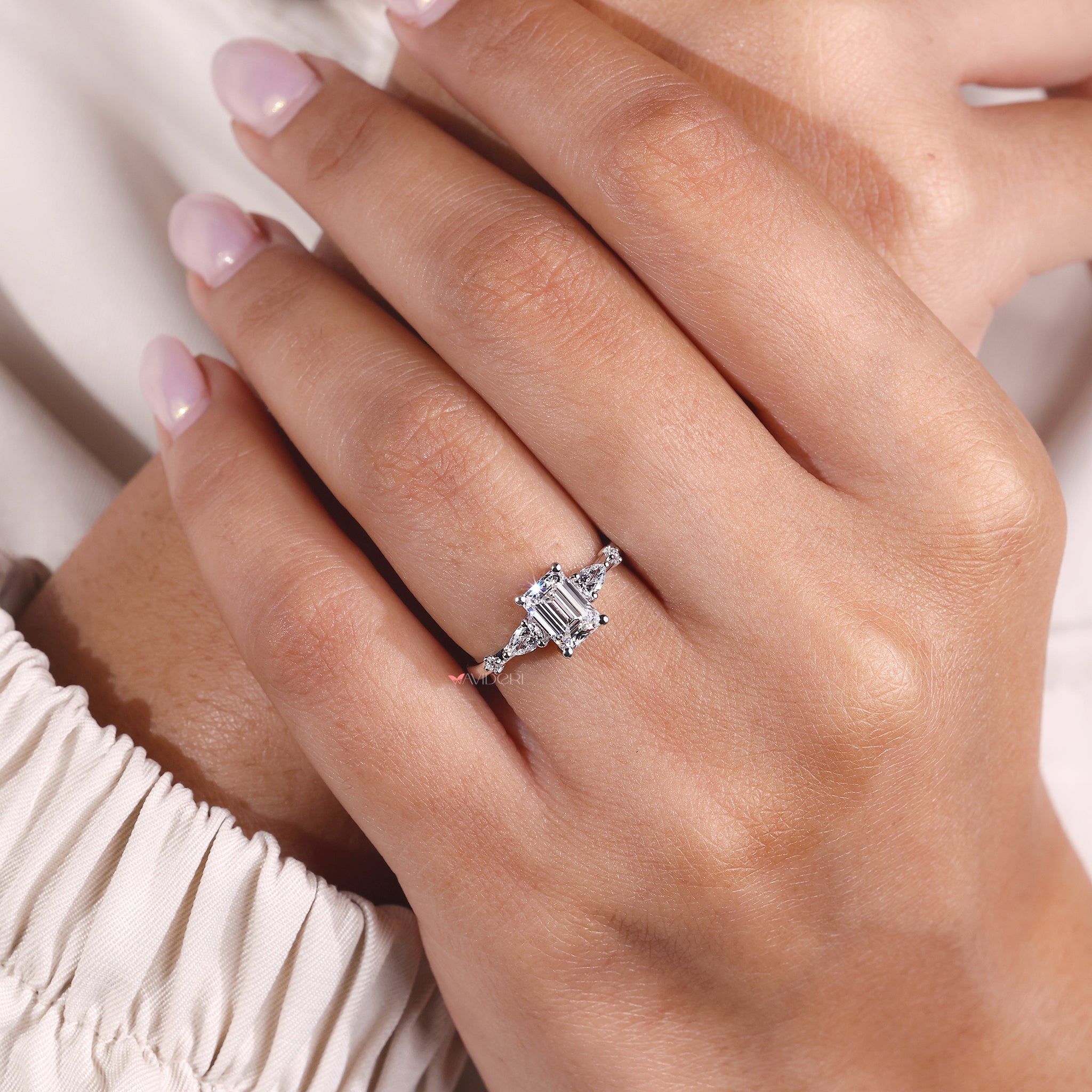 Five stone engagement ring featuring emerald diamond ring and prong setting ring design.
