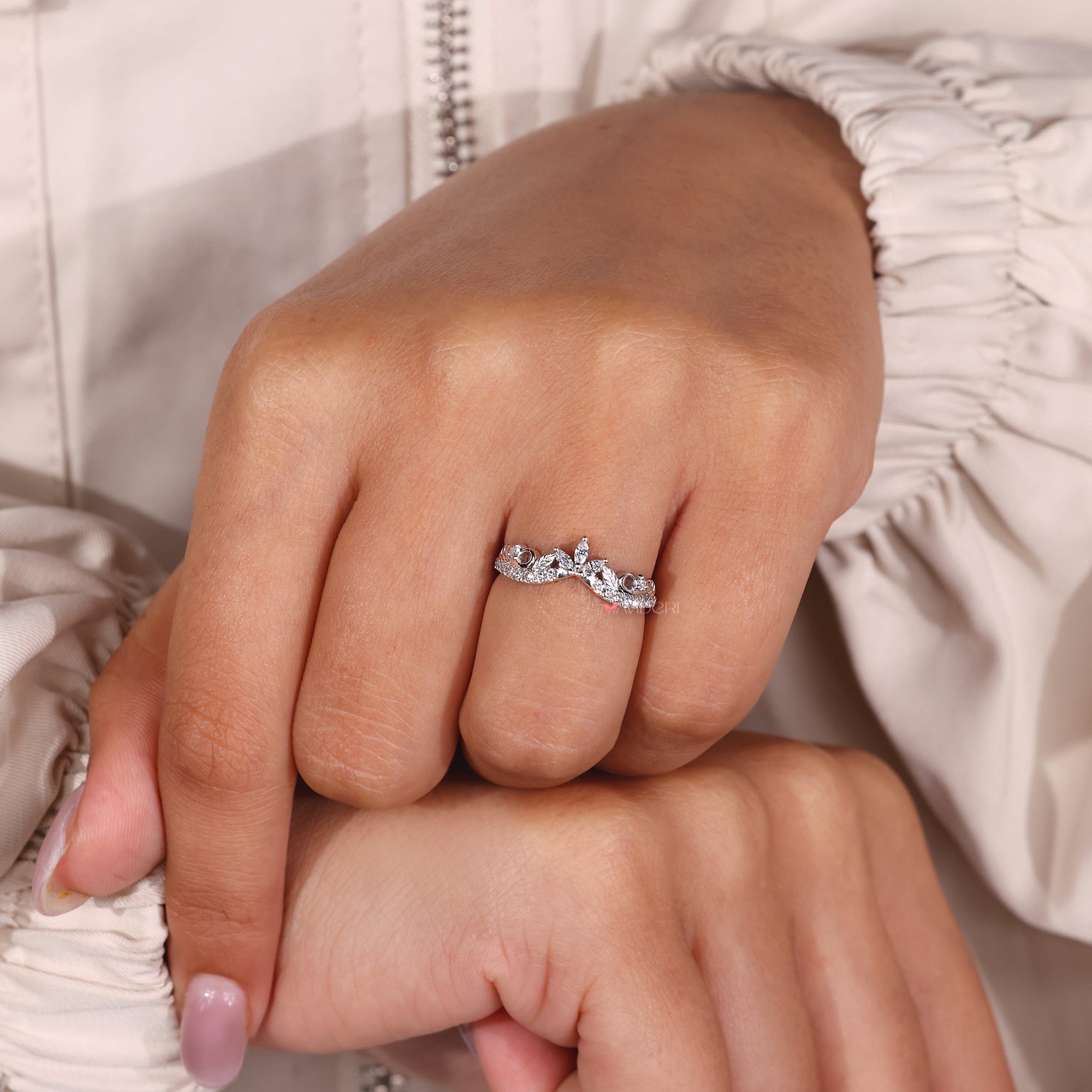 Nature-inspired ring with a curvy band and marquise diamonds, perfect for nature lovers.