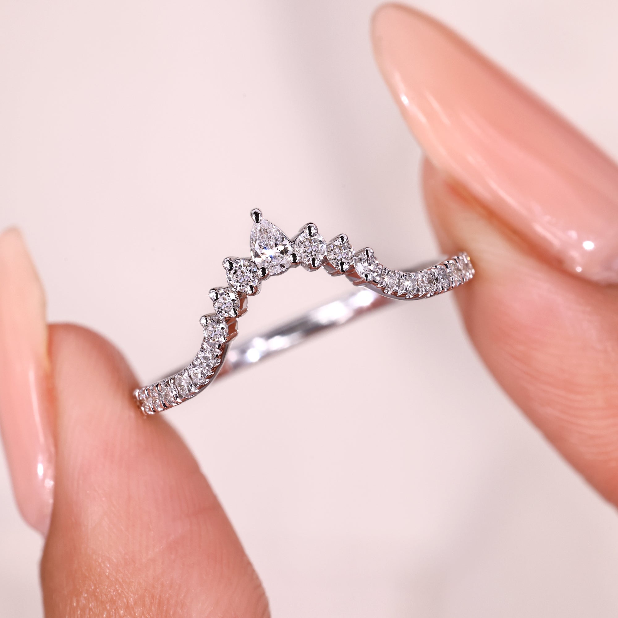 Pear and round diamond V shaped band.
