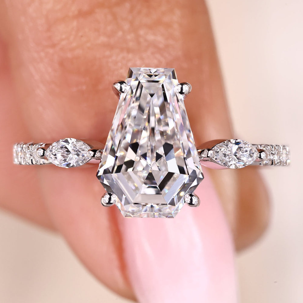 Coffin cut diamond ring with marquise and round side stones.