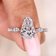 Coffin cut diamond ring with marquise and round side stones.