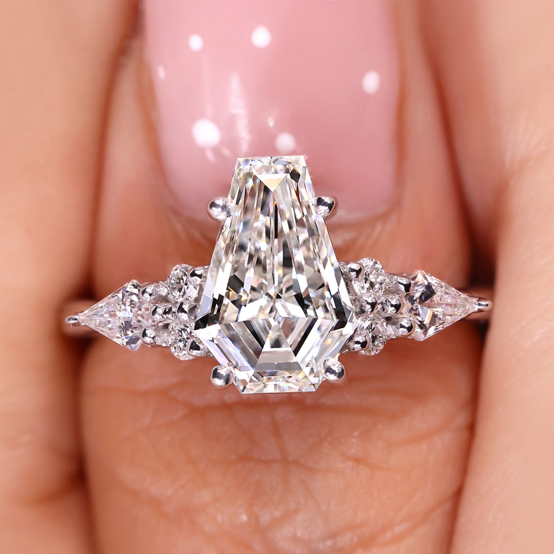 Coffin cut diamond engagement ring with seven stone design.