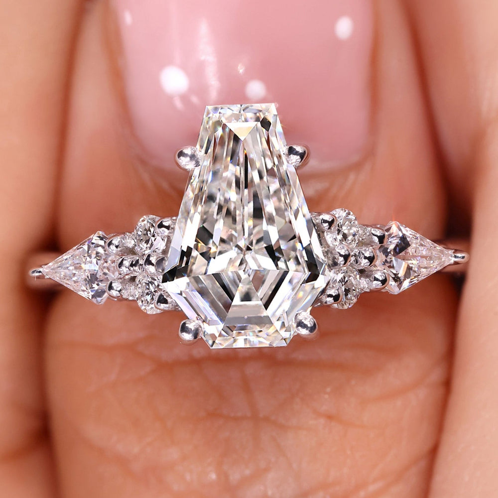 Coffin cut diamond engagement ring with seven stone design.
