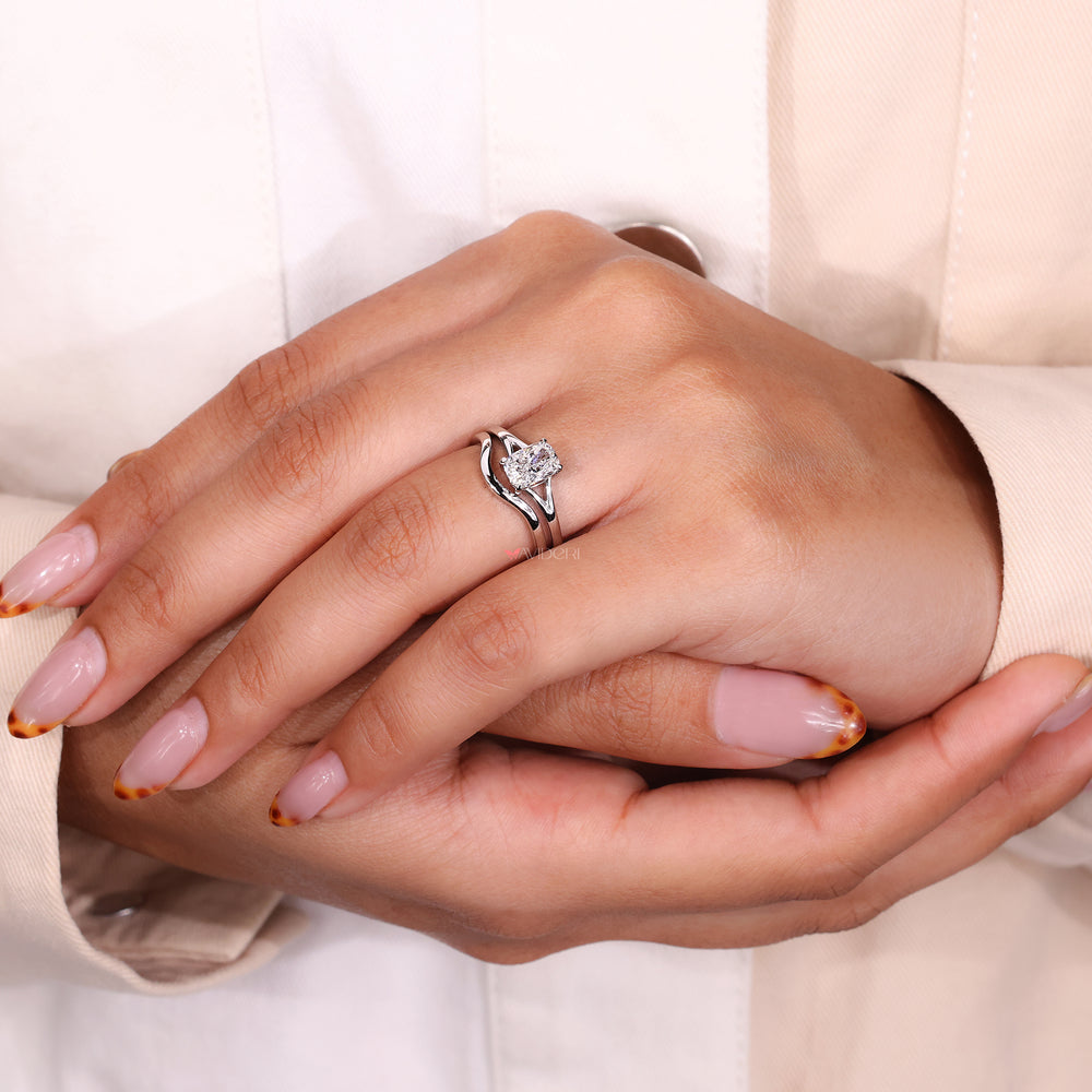 Split shank ring with cushion cut diamond and classic wedding band.