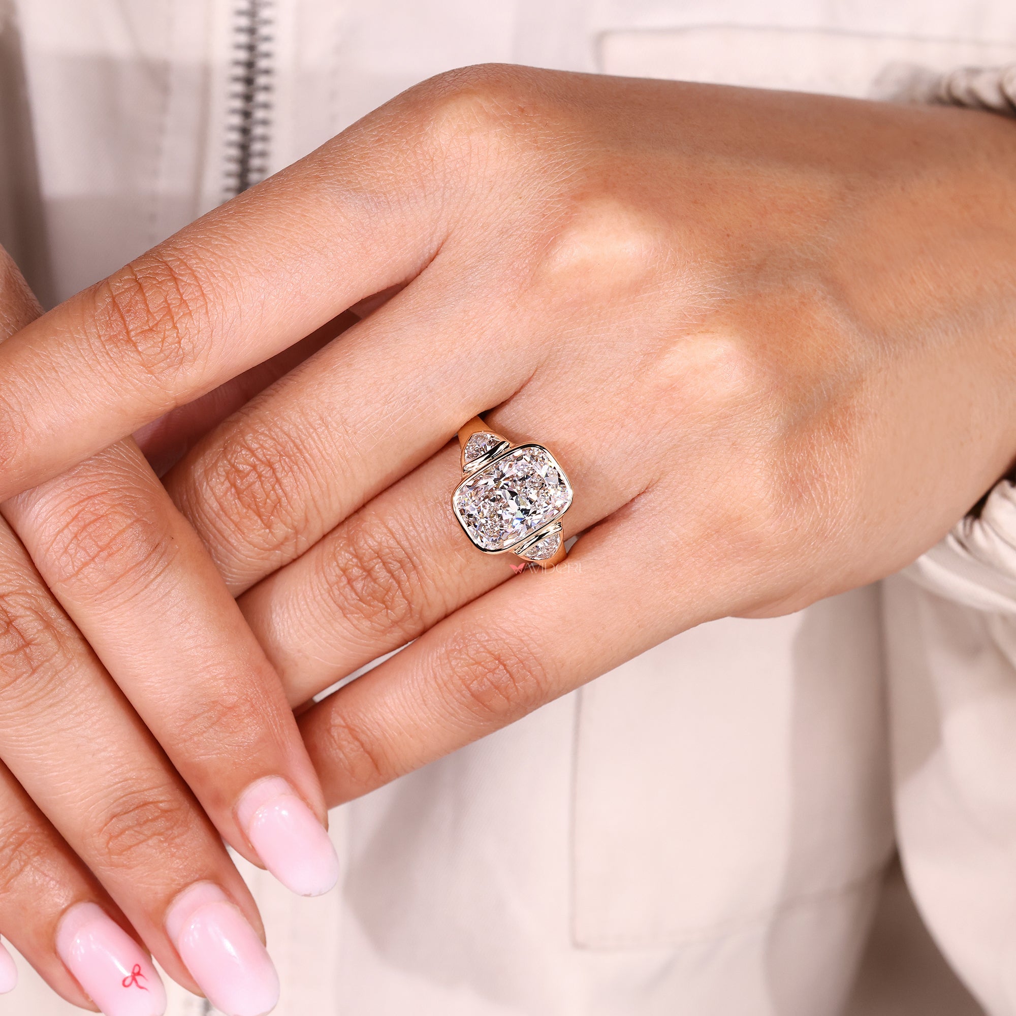 Cushion cut diamond ring with trillion side stone accents.