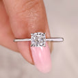 Cushion cut diamond ring with solitaire setting.