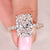 Cushion cut diamond ring with round diamond pave band.
