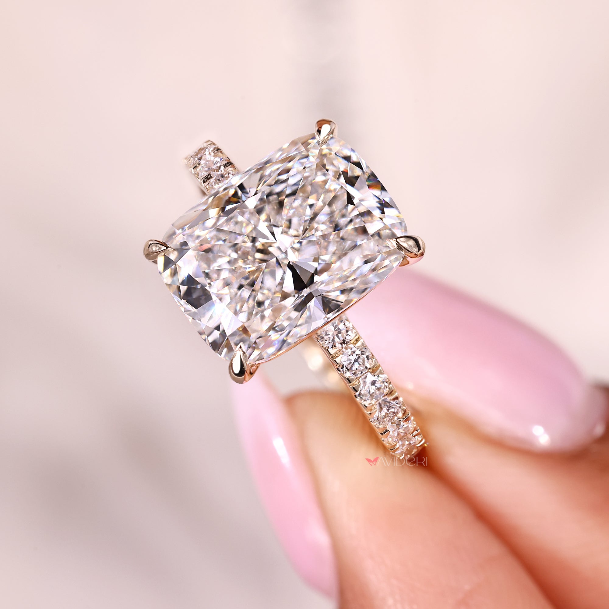 White metal cushion cut diamond ring with pave band.
