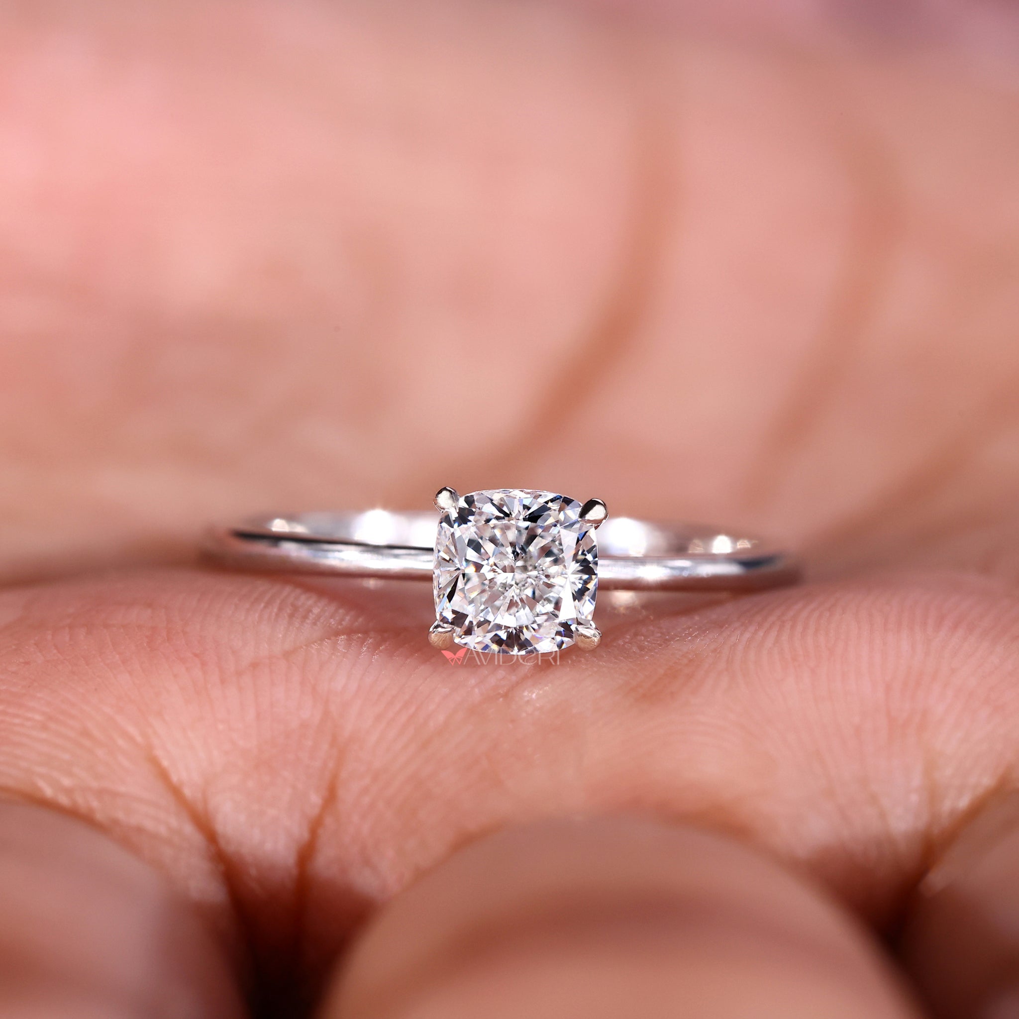 Cushion cut solitaire ring crafted with a single diamond and minimalist design.
