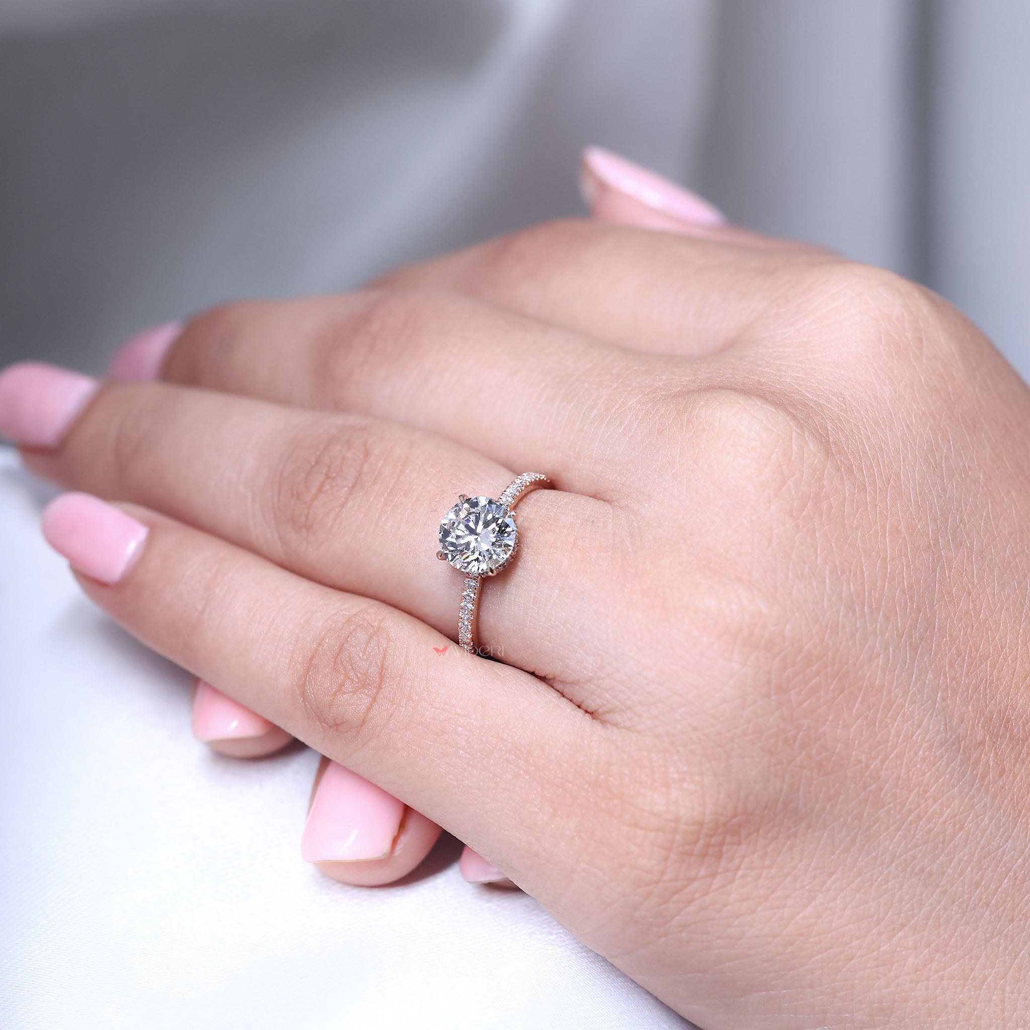 Round cut diamond engagement ring designed with Hidden Halo engagement ring and pave setting band.
