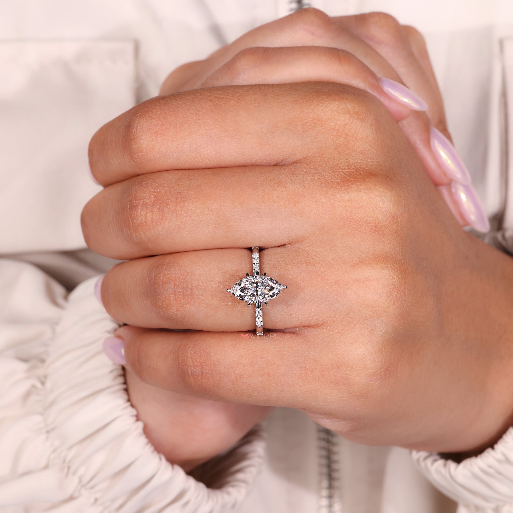 marquise and round diamond engagement ring with distance pave band design.
