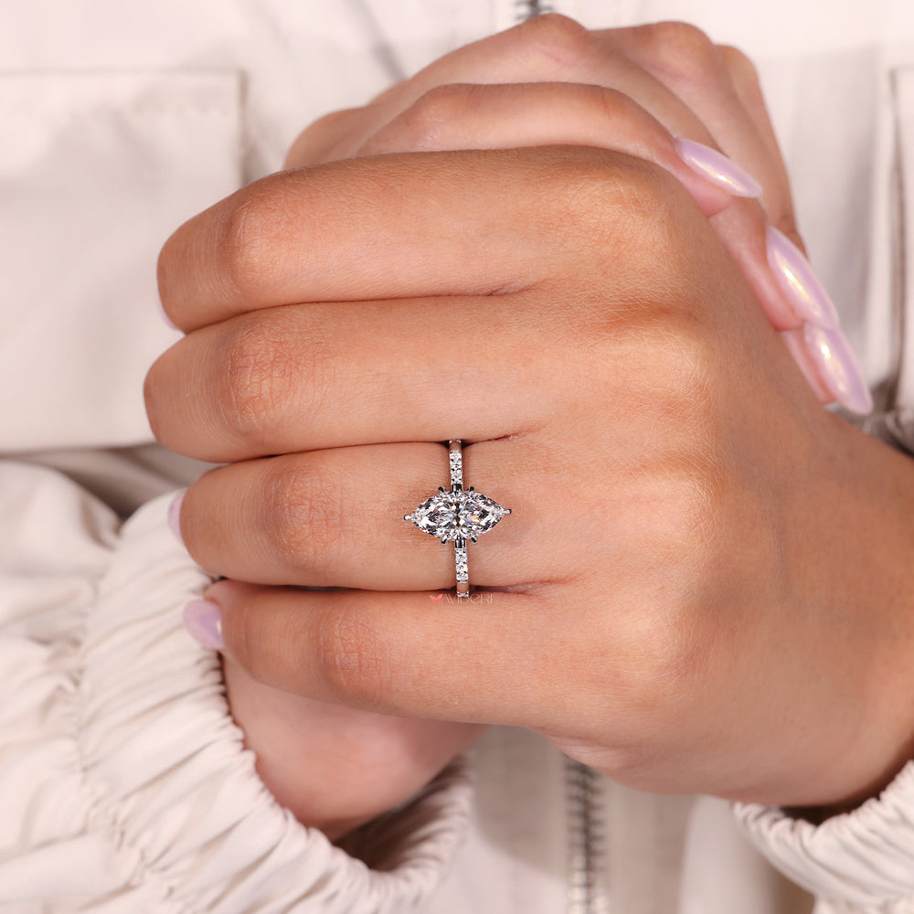 marquise and round diamond engagement ring with distance pave band design.