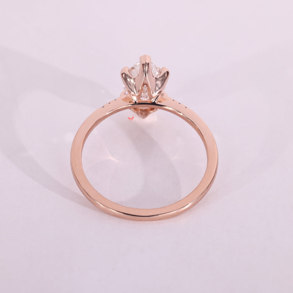 Round cut side diamond engagement ring adds perfect balance to the marquise center.
