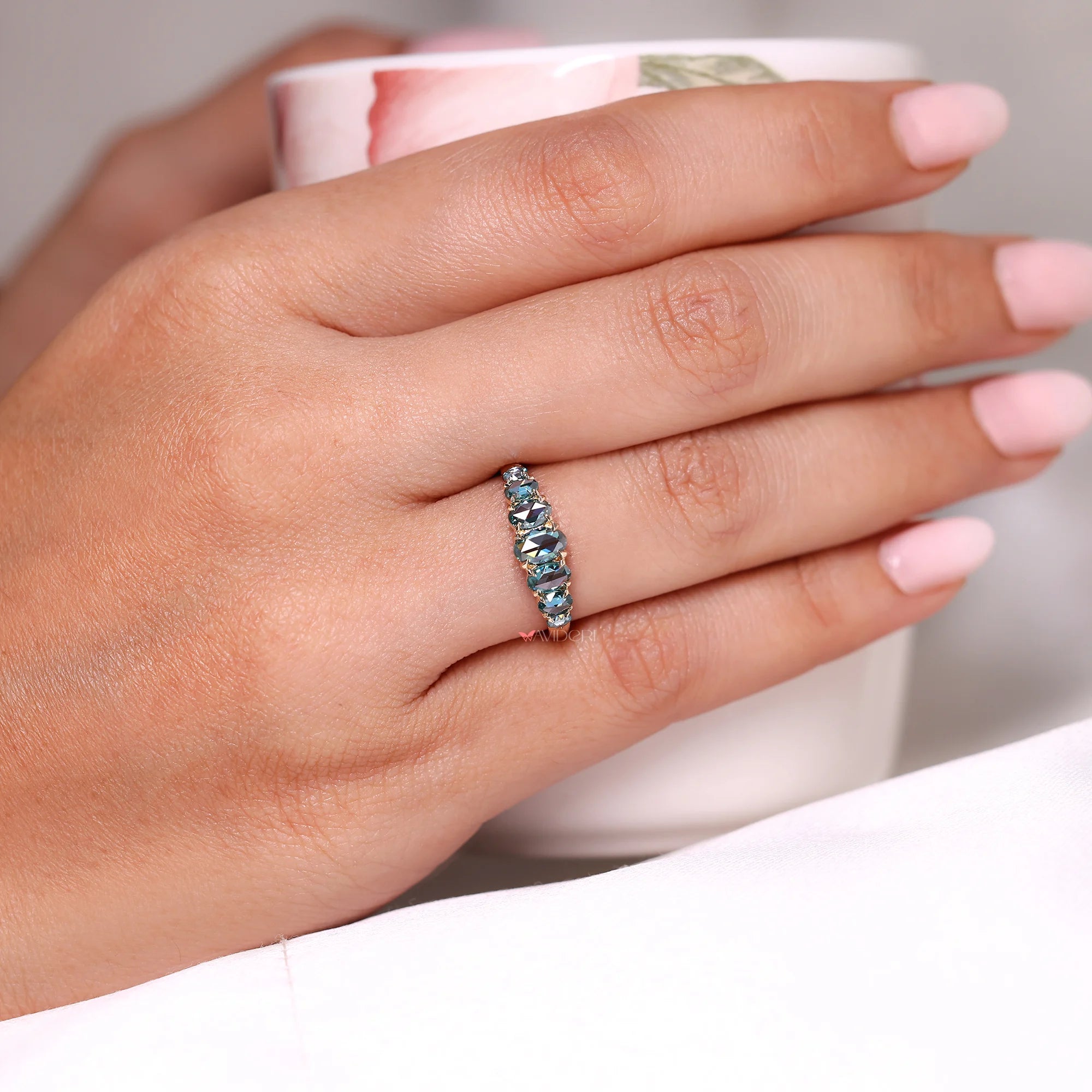 Cyan blue stone band with claw prong setting.
