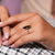 Round cut ring featuring a black moissanite center.