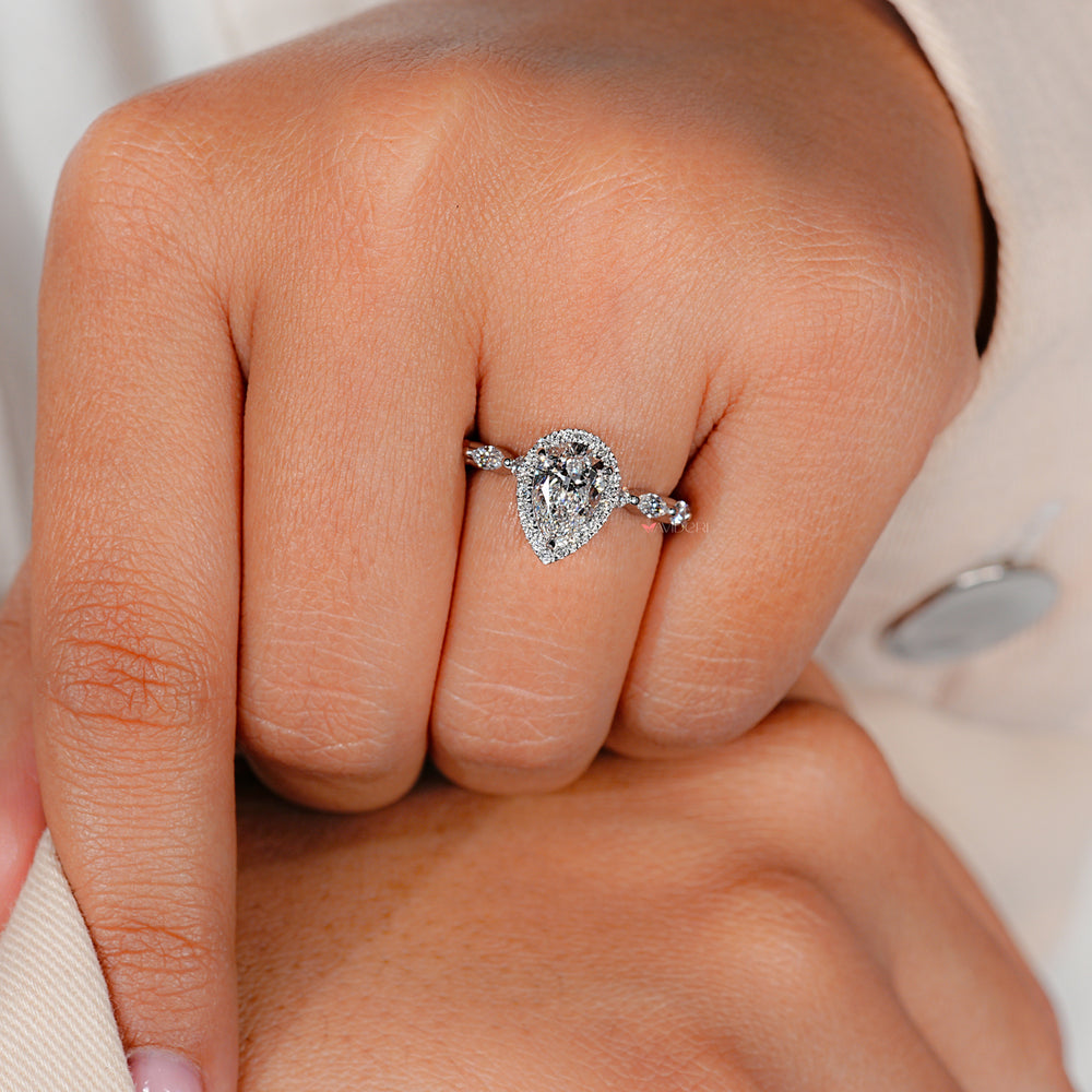 Halo ring with round and marquise side stones for added sparkle.
