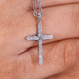 Infinite and cross pendant necklace with round diamonds.