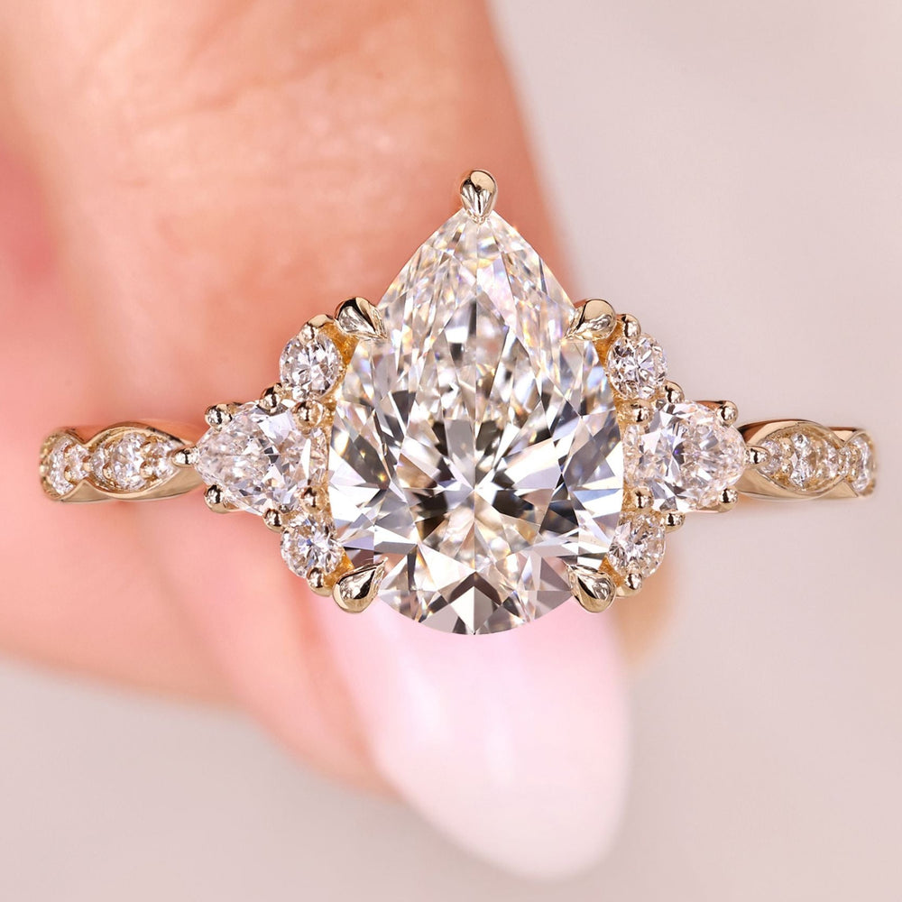 Pear cut diamond ring with cluster vintage style.
