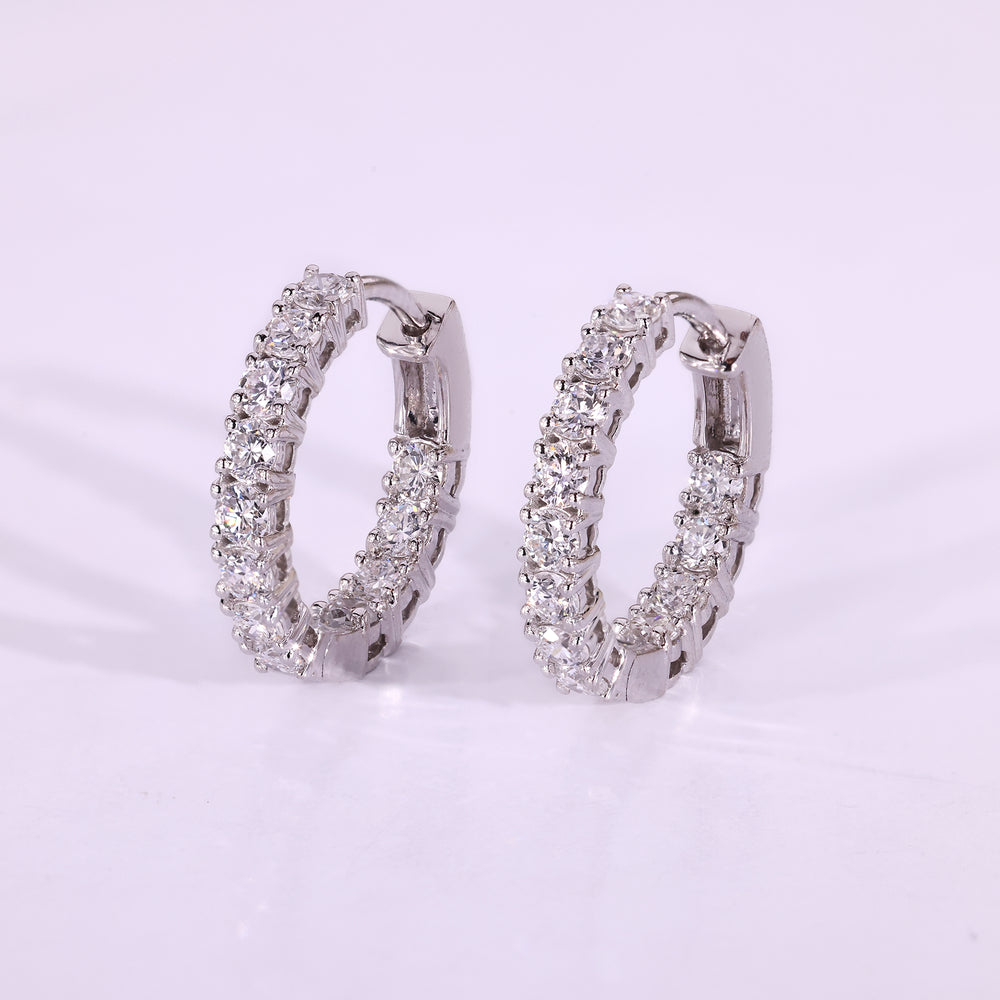 Round diamond earrings set in white gold hoops.