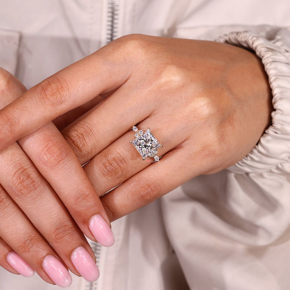 Princess cut diamond ring with marquise side accents.