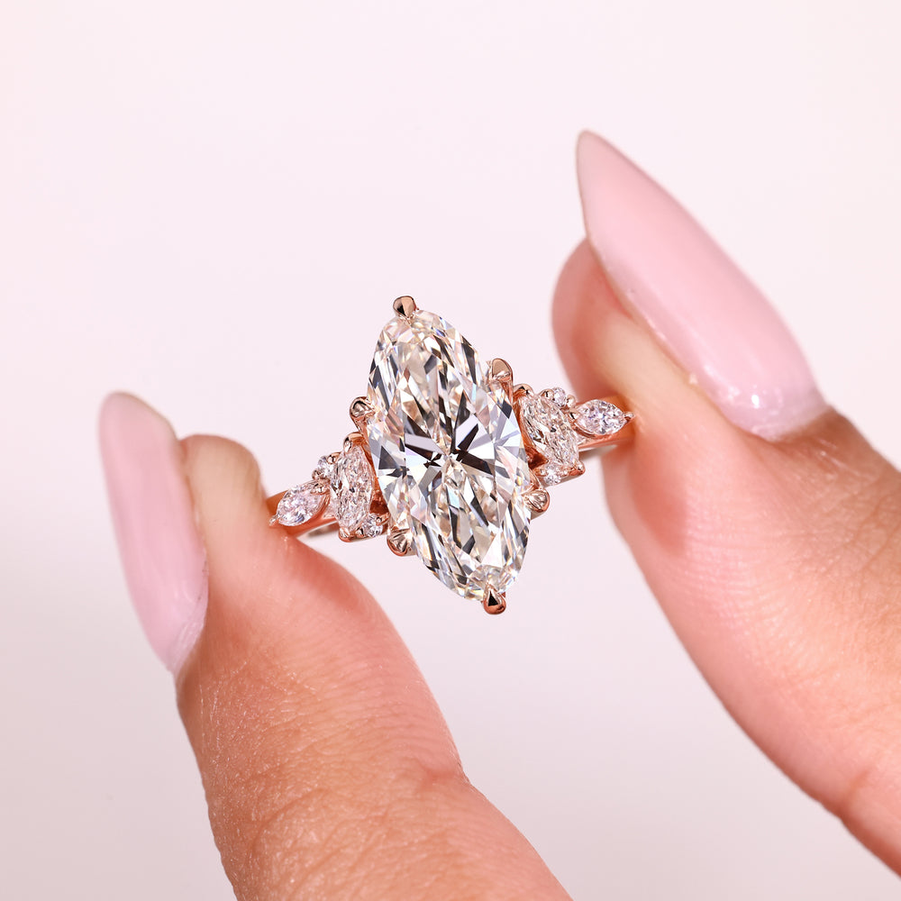 Elegant moval diamond ring with round accents.
