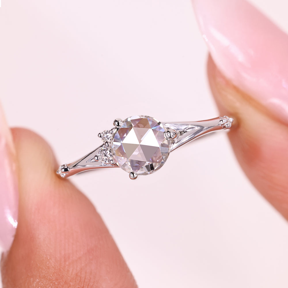 Five stone ring with split shank and diamonds.
