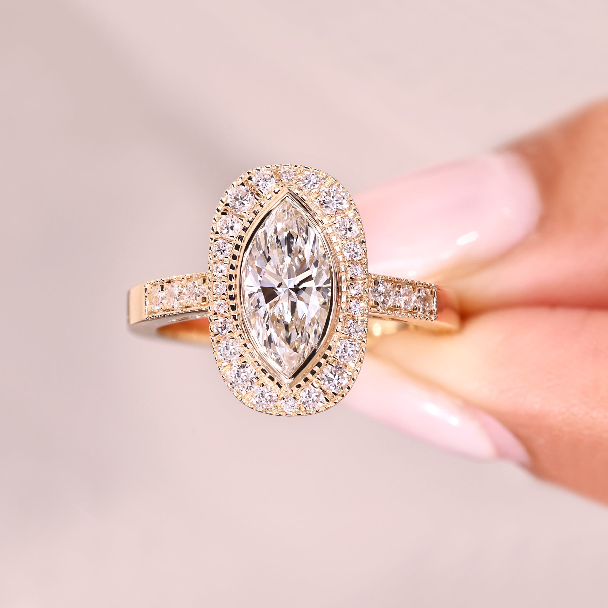 Bezel set marquise diamond with pave band.
