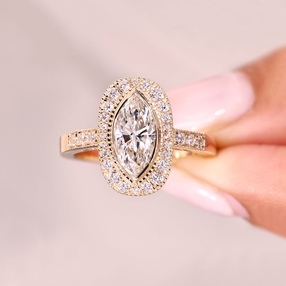 Bezel set marquise diamond with pave band.
