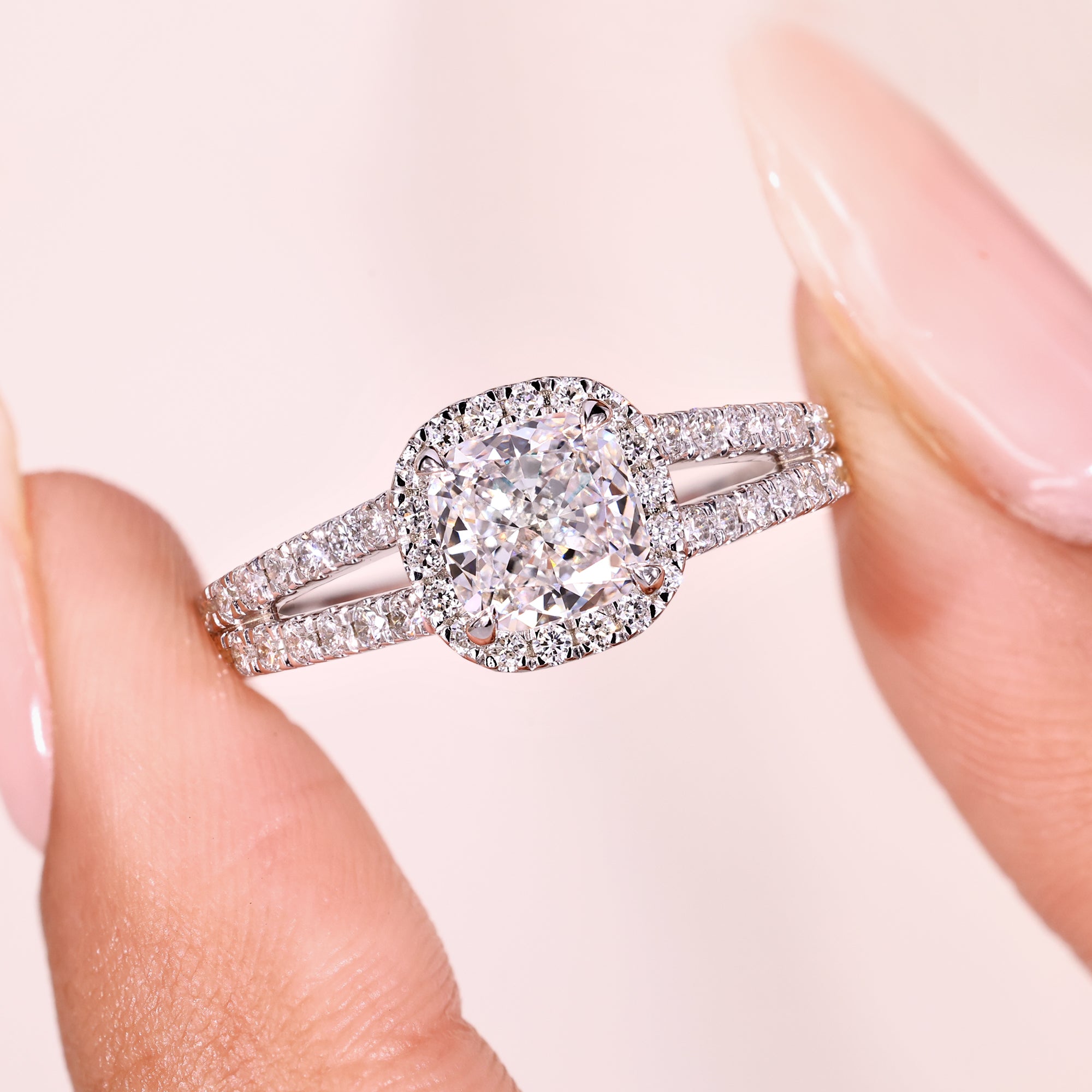 Cathedral setting cushion cut diamond halo ring.
