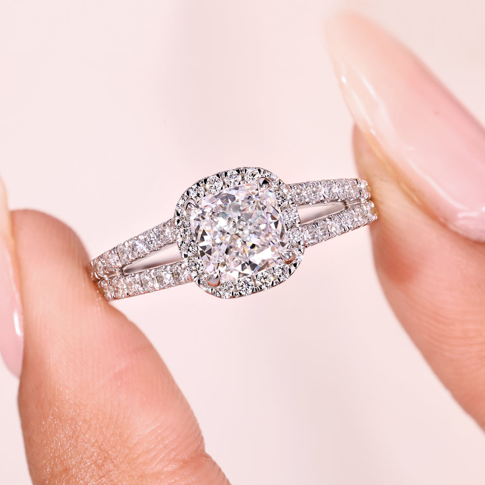 Cathedral setting cushion cut diamond halo ring.
