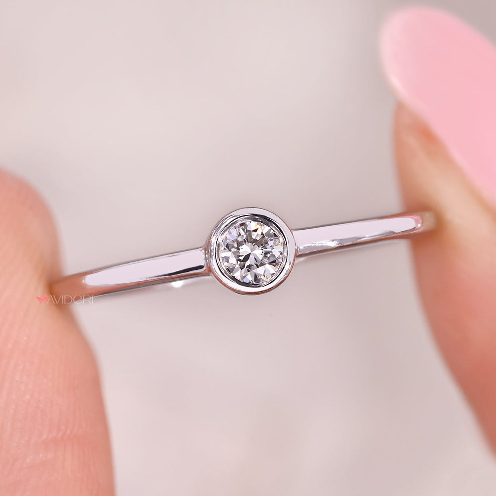 Bezel diamond ring with round diamond solitaire style.

