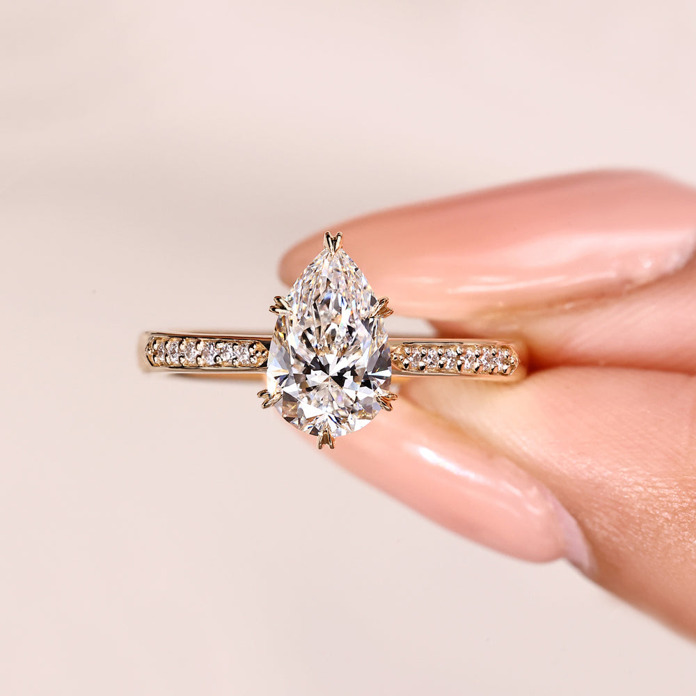 Pear diamond ring with heart shaped prong setting.
