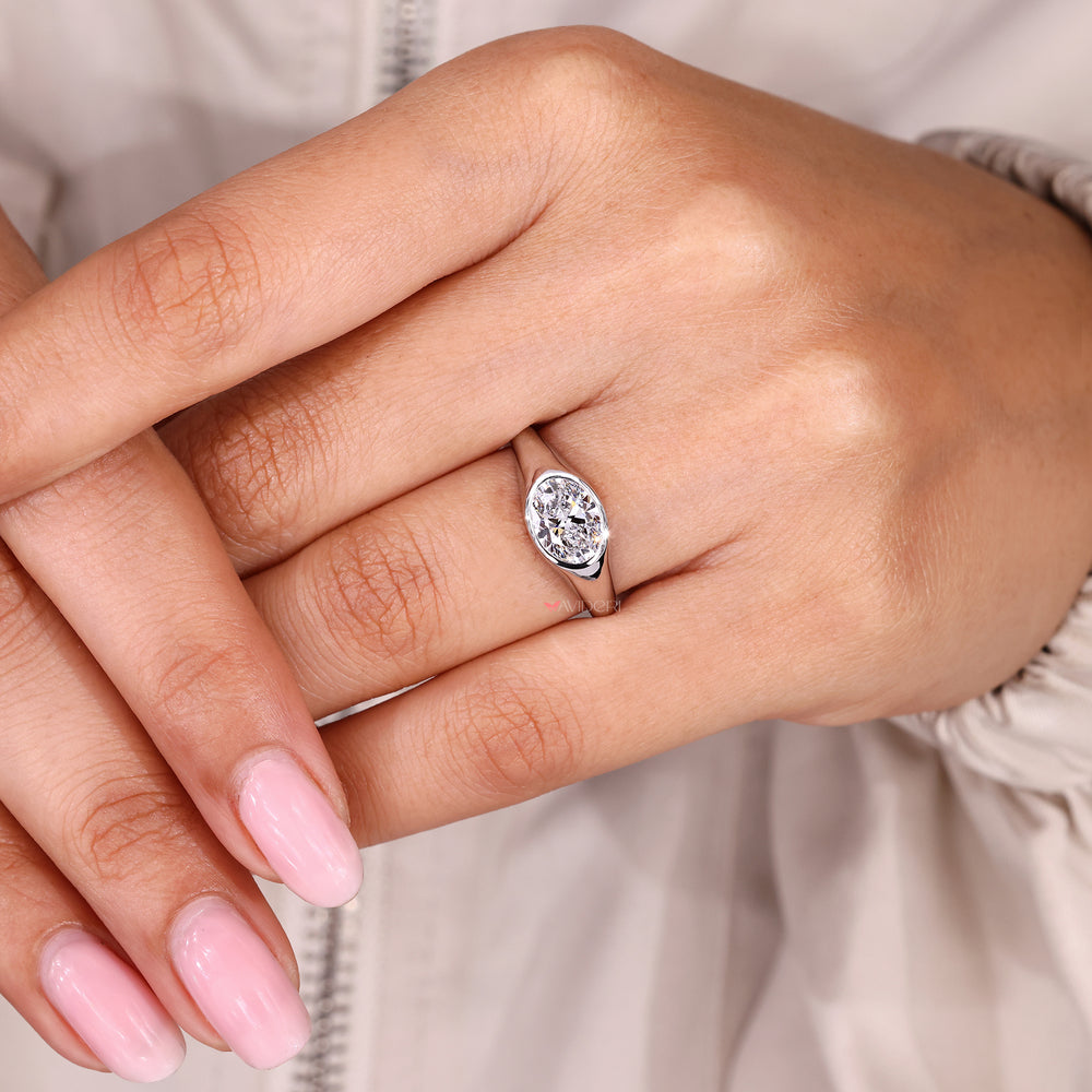 Oval cut diamond ring with minimalist solitaire look.
