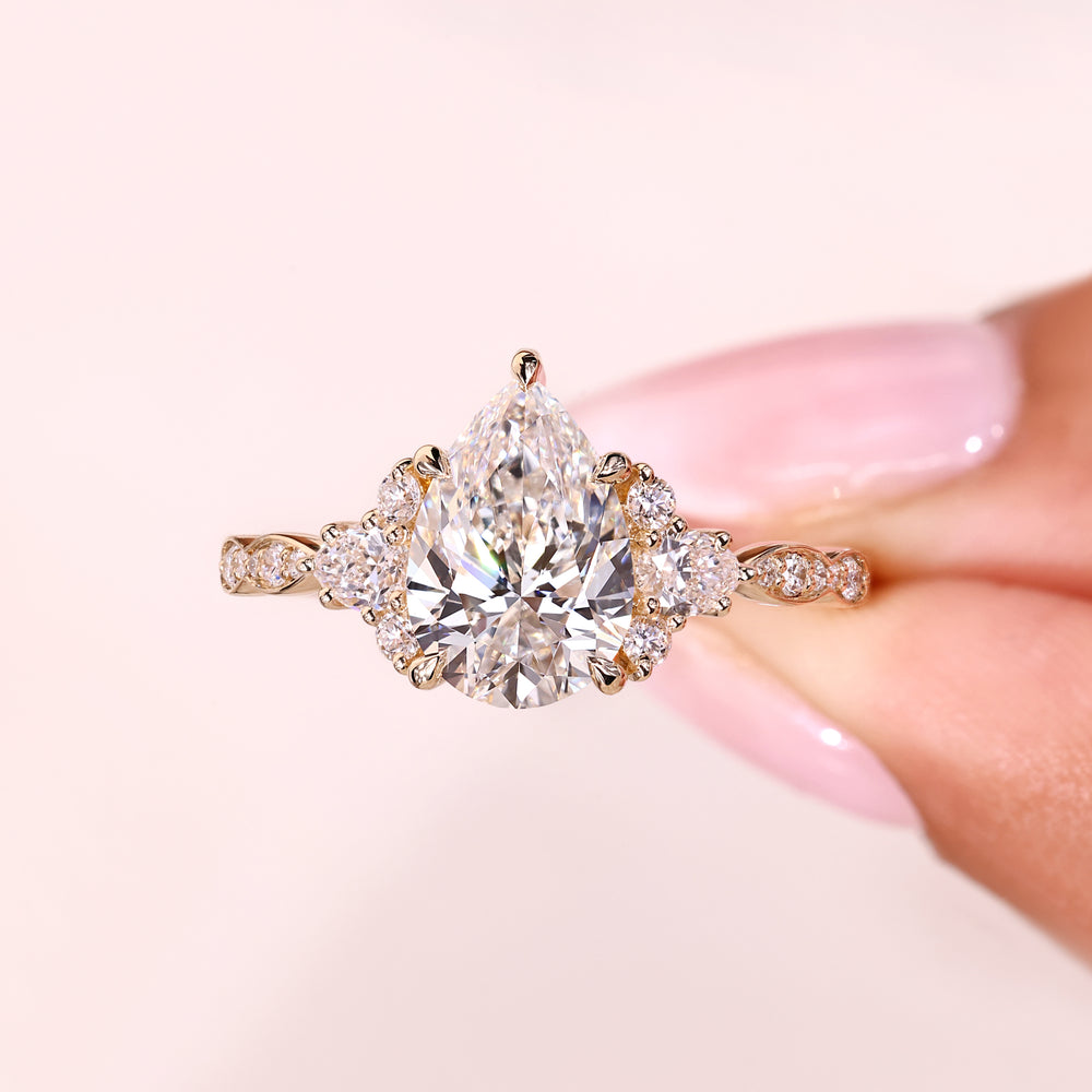 Pear cut ring with muse setting and side stones.
