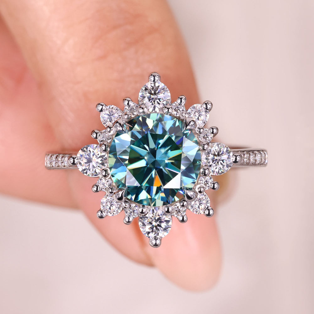 Round cyan blue moissanite cluster engagement ring.
