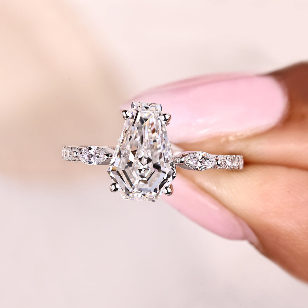 Coffin cut ring with marquise accents and pave band.
