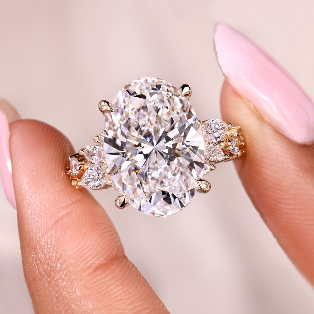 Oval cut diamond engagement ring with cluster design.
